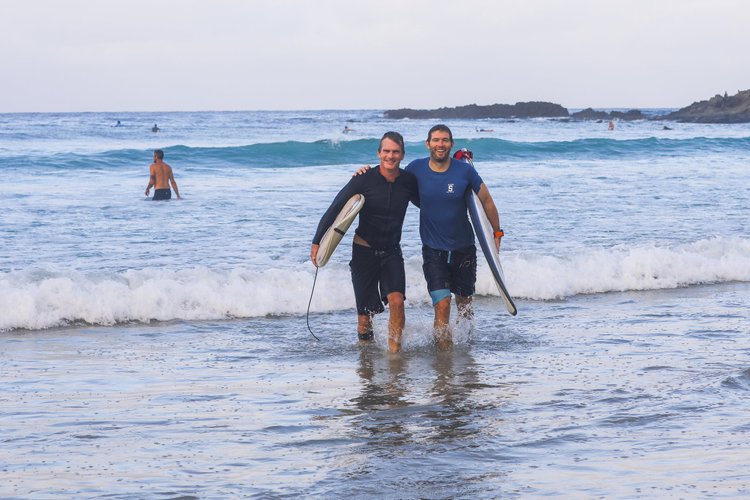 Two surfers walking out of the water